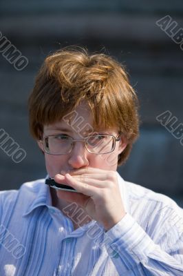 man playing on harmonica