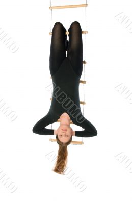 Woman hanging on a rope ladder