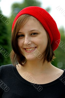 Portrait of a young girl with red cap.