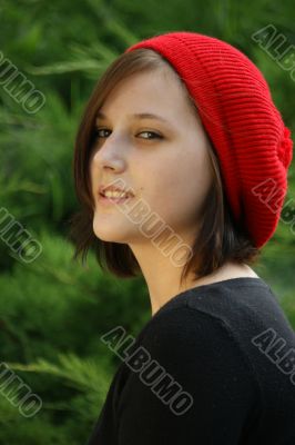 Portrait of a young girl with red cap.