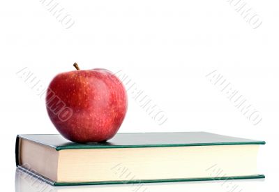 A red apple red on a green paper