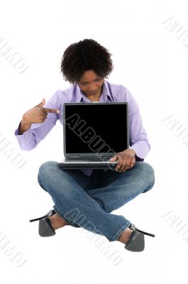 Beautiful  girl sitting pointing a laptop