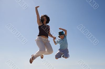 Mother and son jumping