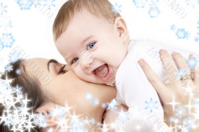 laughing baby playing with mother