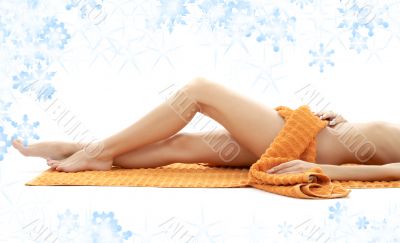 long legs of relaxed lady with orange towel