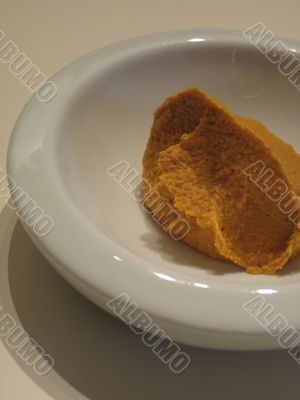 cold hummus in a white dish