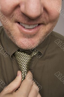 Smiling Man Fixing Tie
