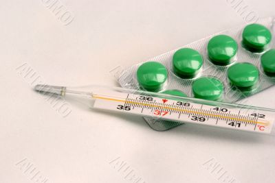 a thermometer and tablets