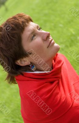 redhead woman sitting on the grass