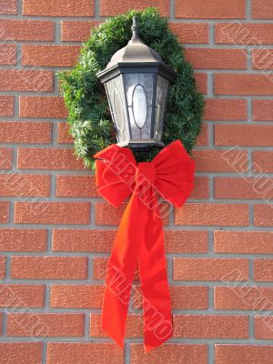 holiday bow around an outdoor light