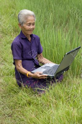 Old Asian with laptop