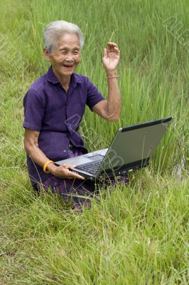 Old Asian with laptop