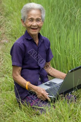 Old Asian with laptop