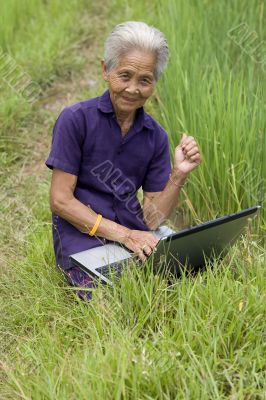 Old Asian with laptop