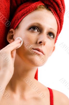 Beautiful wellness girl with  red towel on her head cleansing he