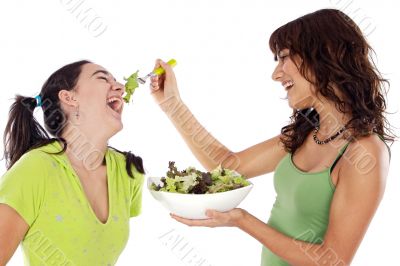 Two beautiful girls with a salad