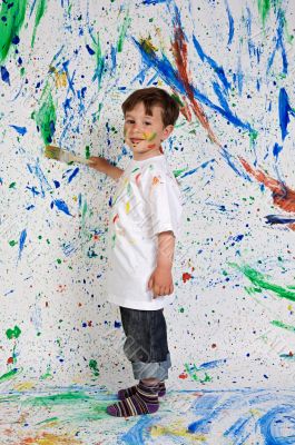 Little boy playing with painting