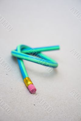 Green rubber pencil twisted into a knot