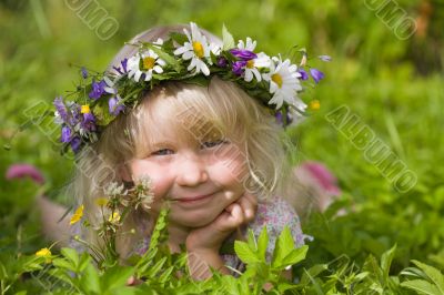 happy little girl on green meadow
