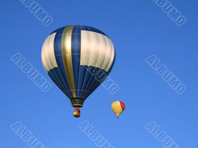 Two hot air balloons in the blue sky