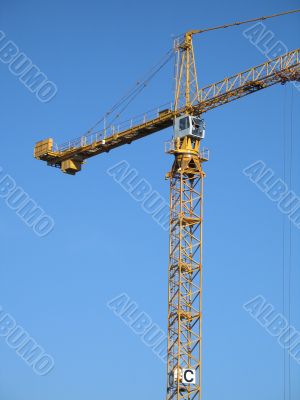 yellow construction crane in the blue sky