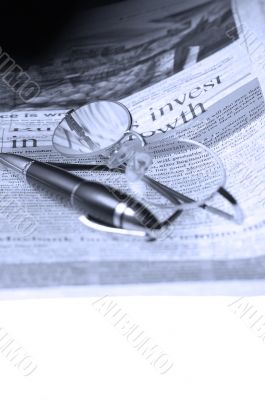 pen and glasses and newspaper