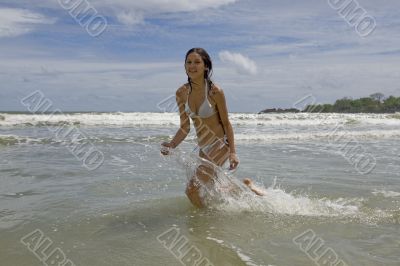 female teenager jumps on the beach