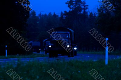 Military lorries going at night