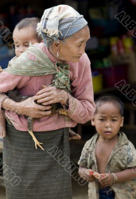 Asia, old woman with chicken and grandson
