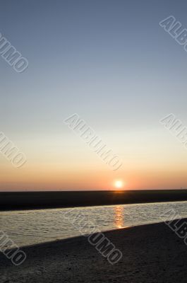 sunrise on the beach on ameland; the netherlands