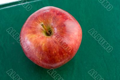 Apple red on a green book