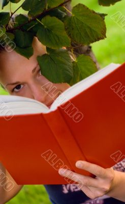 woman with book under the tree
