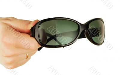 glasses on a womanish hand