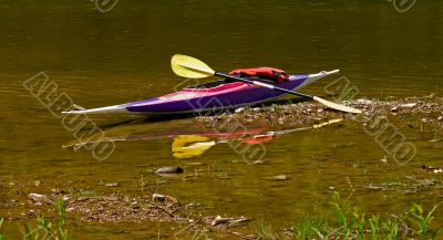 Canoe on a river bank