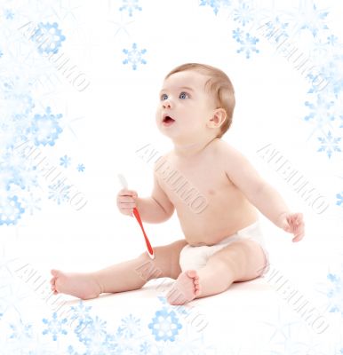 baby boy in diaper with toothbrush