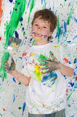 Little boy playing with painting