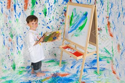 Little boy playing with painting