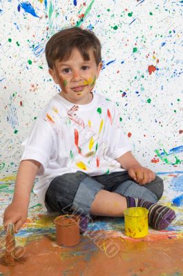 Little boy playing with painting