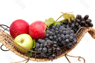 Bunches of grapes and apples in basket.