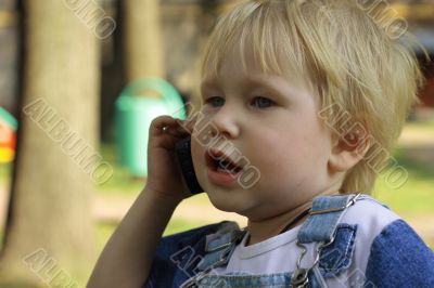  child talks by a mobile phone