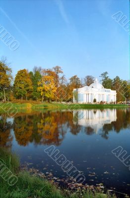 Classical building near the pond in autumn vertical