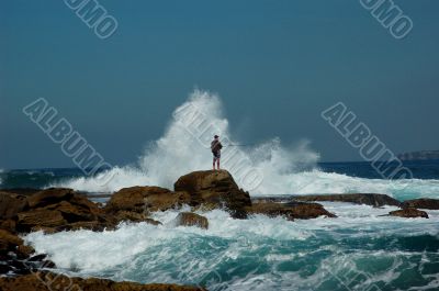 Fisherman in the sea with wave