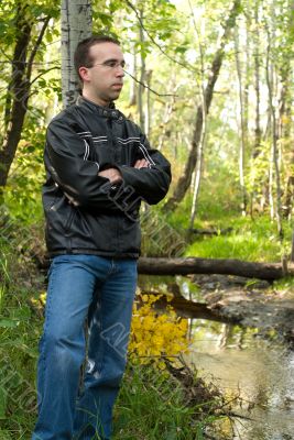 Man Relaxing By A Stream