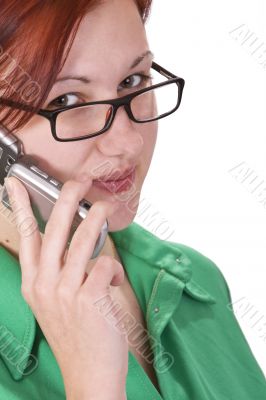 Redheaded girl talking on a mobile phone