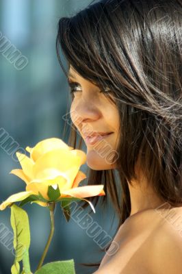 Young woman with a beautiful yellow rose