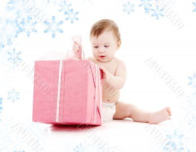 baby boy in diaper with big gift box