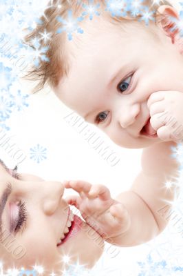 happy blue-eyed baby boy touching mama
