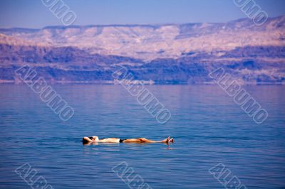 Man floating at the Dead Sea