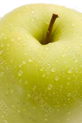 Macro of green delicious apple with reflection