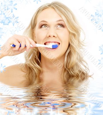 happy blond with toothbrush in water